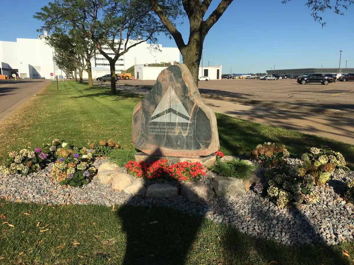 The Delta Rock installed at Minneapolis–Saint Paul International Airport surrounded by flowers