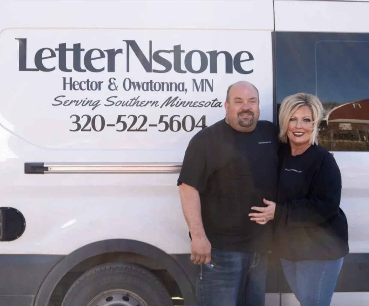 Kevin and Karen, founders of LetterNstone, standing in front of their work van