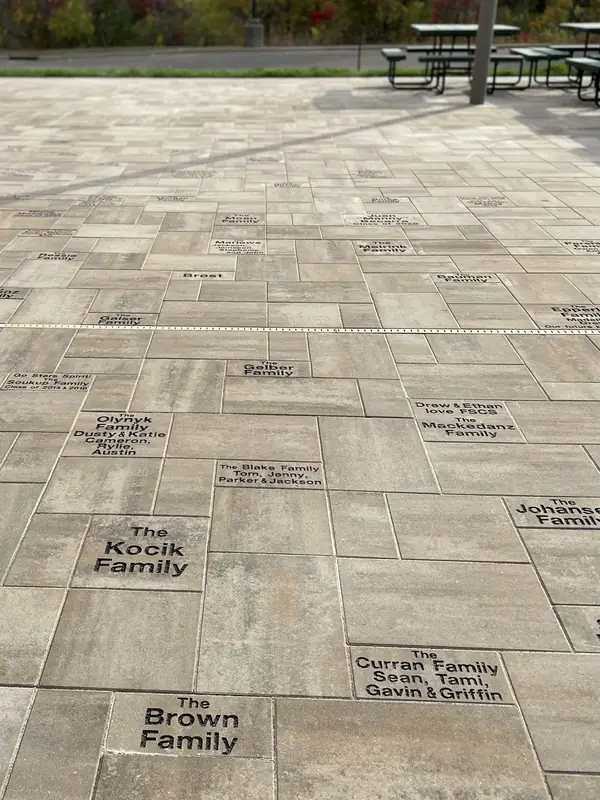 Custom engraved stone pavers with names and inscriptions set in a memorial walkway