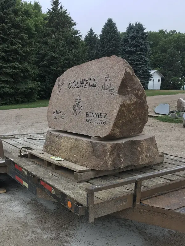 A newly manufactured custom granite headstone with precision engraving, ready for installation