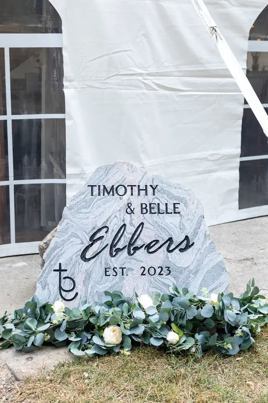 A custom engraved wedding rock with a couple's names and wedding date, crafted by LetterNstone
